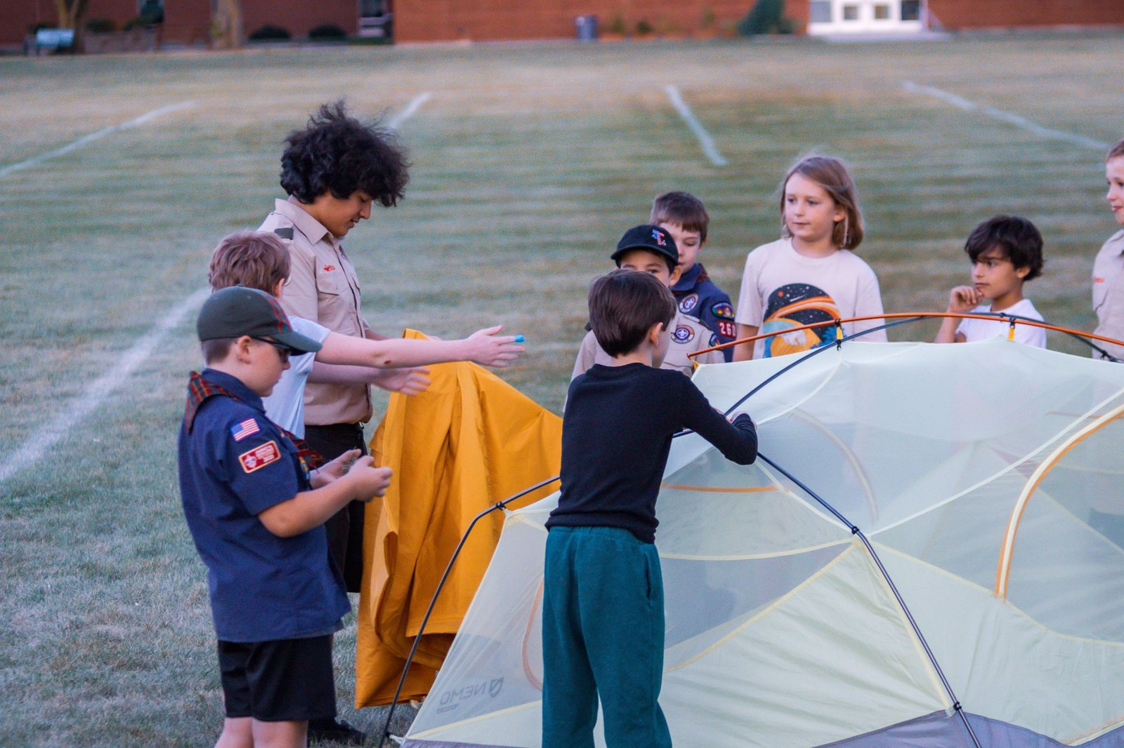 Scouts working together to pitch tents