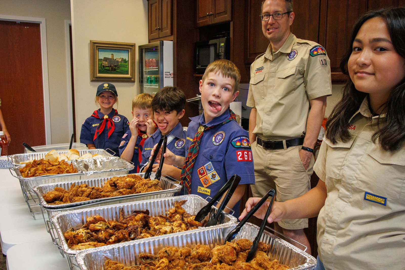 Pack 260 Scouts and leaders preparing to serve food at the VFW